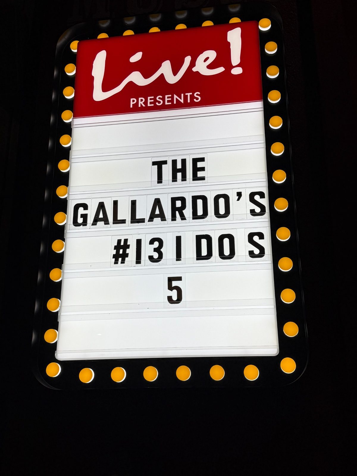 A lit marquee number five at a 13 I DO'S ceremony